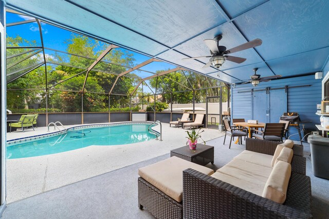outdoor pool featuring a patio, outdoor dining area, and glass enclosure