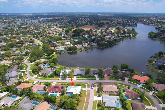 drone / aerial view featuring a water view and a residential view
