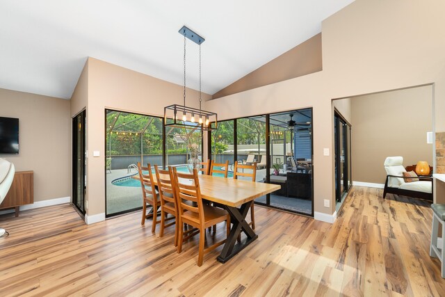 dining area featuring light wood-style floors, baseboards, and a healthy amount of sunlight