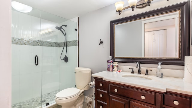 full bathroom featuring vanity, toilet, and a stall shower
