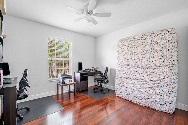 office space featuring baseboards, wood finished floors, and ceiling fan