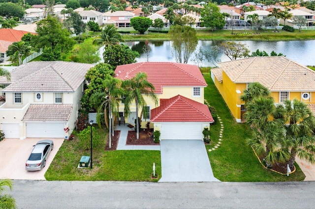 drone / aerial view with a residential view and a water view
