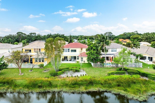 birds eye view of property with a water view and a residential view