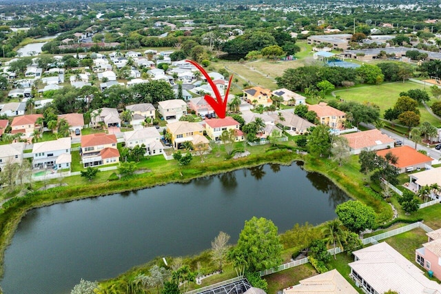 drone / aerial view featuring a residential view and a water view