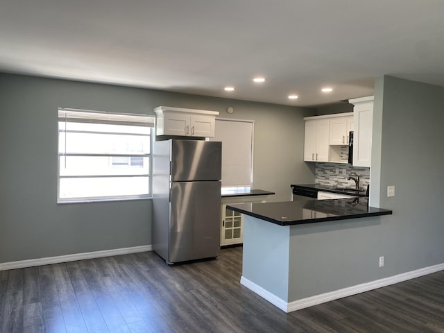 563 Capri L, Delray Beach, FL 33484 - kitchen with freestanding refrigerator, recessed lighting, dark wood-style floors, and white cabinets