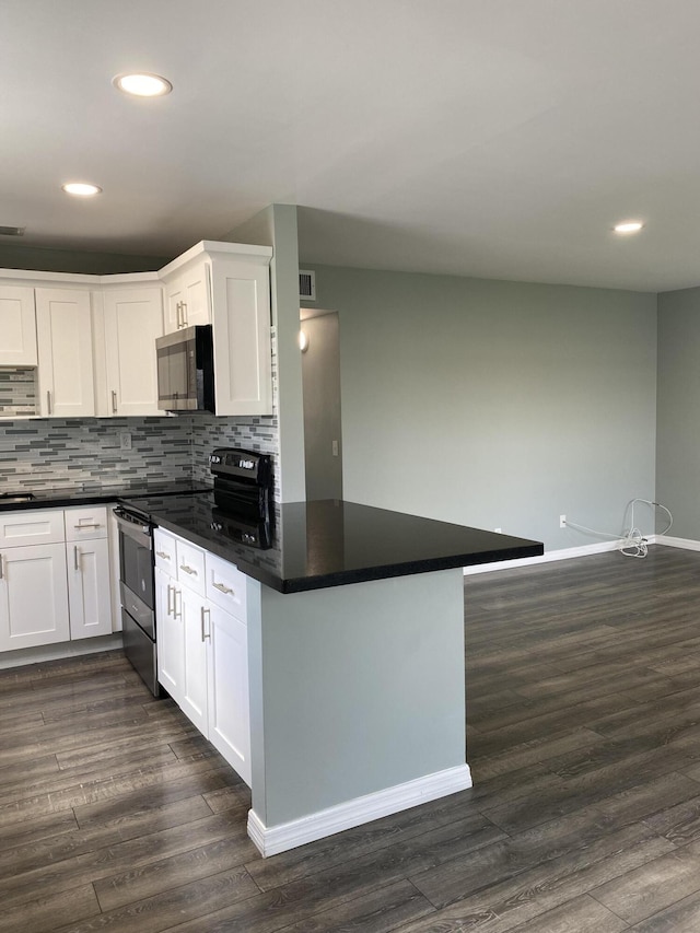 563 Capri L, Delray Beach, FL 33484 - kitchen featuring appliances with stainless steel finishes, recessed lighting, dark countertops, and white cabinetry