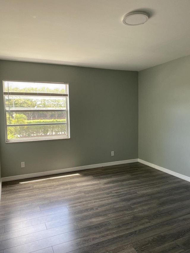 563 Capri L, Delray Beach, FL 33484 - spare room with baseboards and dark wood-style floors