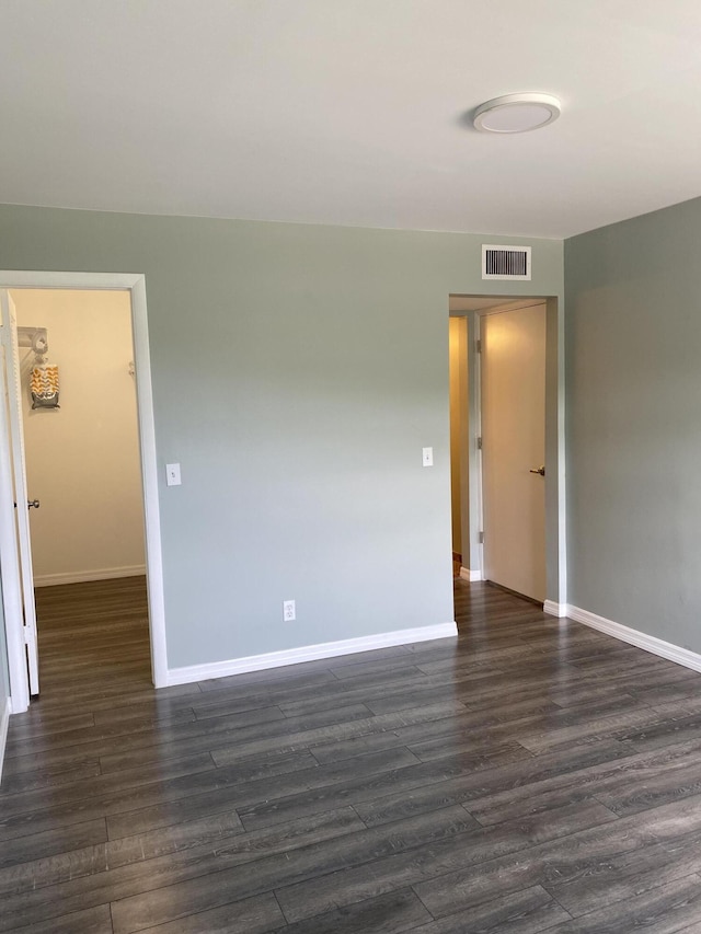 563 Capri L, Delray Beach, FL 33484 - empty room featuring baseboards and dark wood finished floors