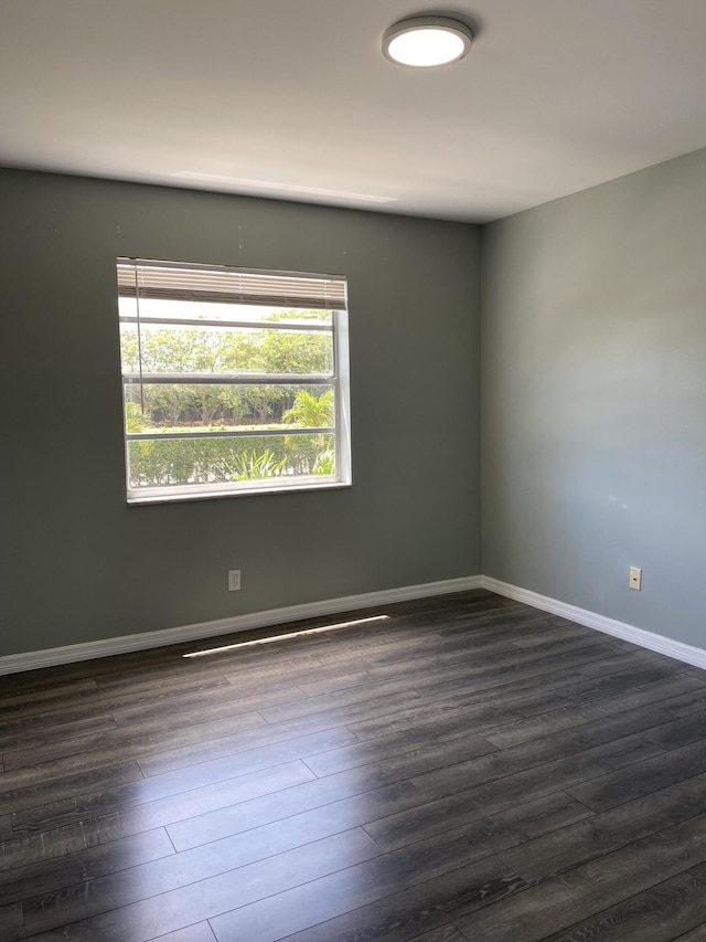 563 Capri L, Delray Beach, FL 33484 - spare room with dark wood finished floors and baseboards