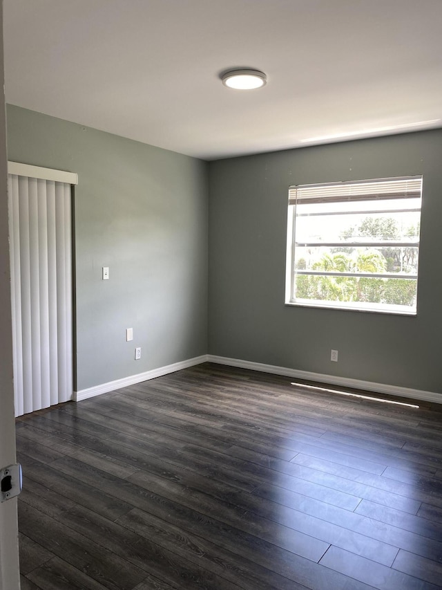563 Capri L, Delray Beach, FL 33484 - spare room featuring dark wood-type flooring and baseboards