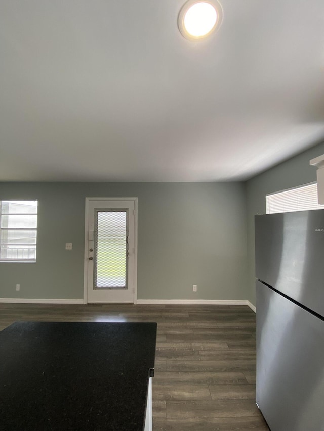 563 Capri L, Delray Beach, FL 33484 - interior space featuring freestanding refrigerator and dark wood-type flooring