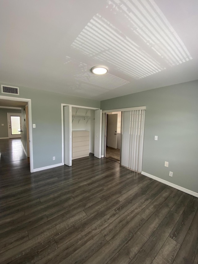 563 Capri L, Delray Beach, FL 33484 - unfurnished bedroom featuring dark wood-type flooring and a closet