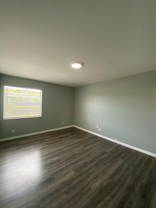 563 Capri L, Delray Beach, FL 33484 - empty room with dark wood finished floors and baseboards