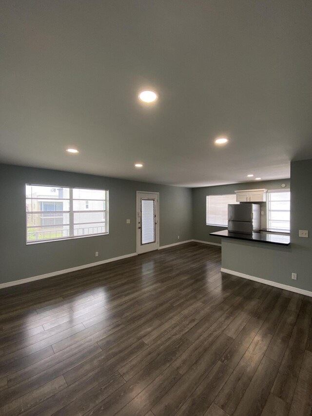 563 Capri L, Delray Beach, FL 33484 - unfurnished living room featuring dark wood-style floors, healthy amount of natural light, and recessed lighting