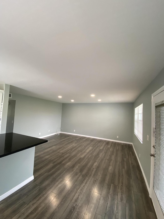 563 Capri L, Delray Beach, FL 33484 - unfurnished living room featuring dark wood-style floors and recessed lighting