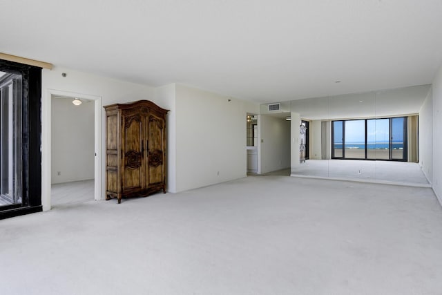 529 S Flagler Dr Unit 25F, West Palm Beach, FL 33401 - unfurnished living room featuring visible vents and carpet floors