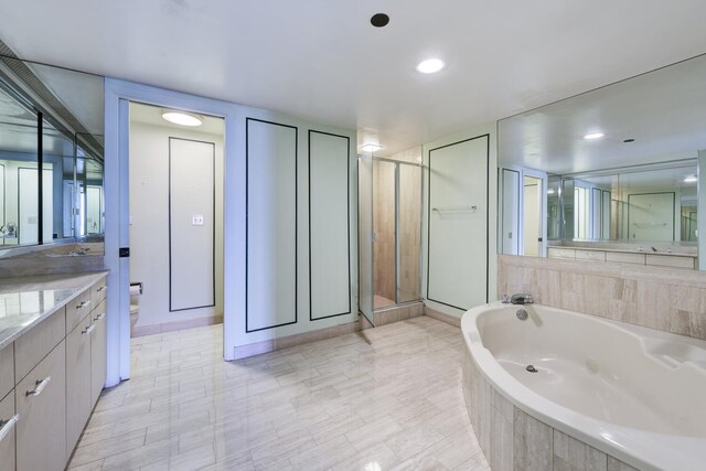 529 S Flagler Dr Unit 25F, West Palm Beach, FL 33401 - full bath featuring vanity, a stall shower, a garden tub, and toilet