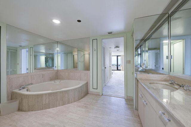529 S Flagler Dr Unit 25F, West Palm Beach, FL 33401 - full bathroom featuring vanity, a bath, and visible vents