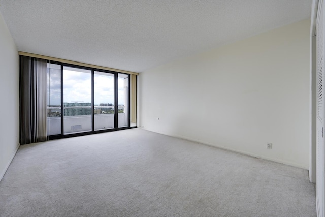 529 S Flagler Dr Unit 25F, West Palm Beach, FL 33401 - empty room with carpet floors and a wall of windows