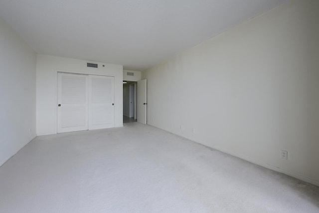 529 S Flagler Dr Unit 25F, West Palm Beach, FL 33401 - unfurnished bedroom featuring light carpet, a closet, and visible vents