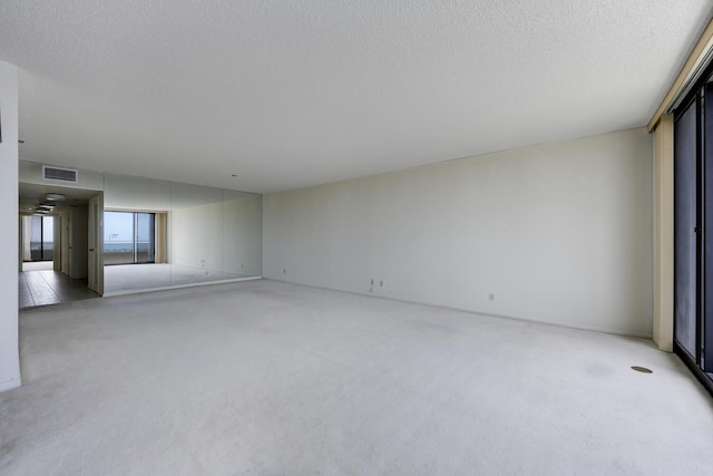529 S Flagler Dr Unit 25F, West Palm Beach, FL 33401 - empty room featuring visible vents, light carpet, and a textured ceiling
