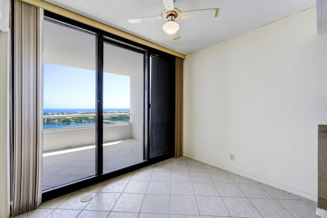 529 S Flagler Dr Unit 25F, West Palm Beach, FL 33401 - empty room with a water view, light tile patterned floors, ceiling fan, and a textured ceiling