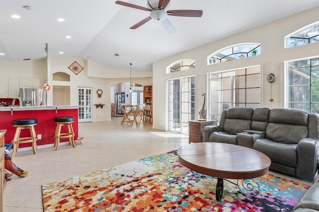 living room featuring recessed lighting, light tile patterned floors, arched walkways, high vaulted ceiling, and ceiling fan