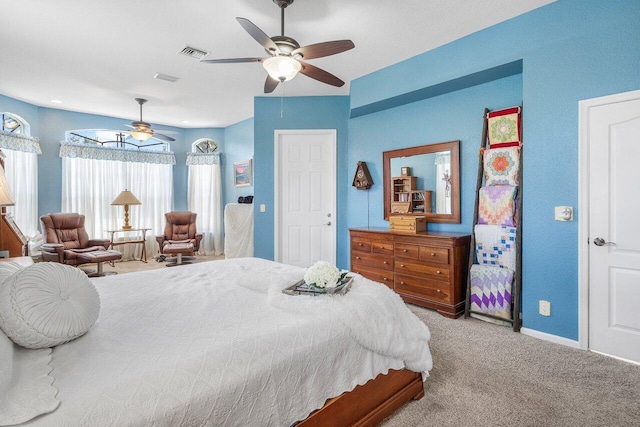 bedroom featuring ceiling fan, baseboards, carpet flooring, and visible vents