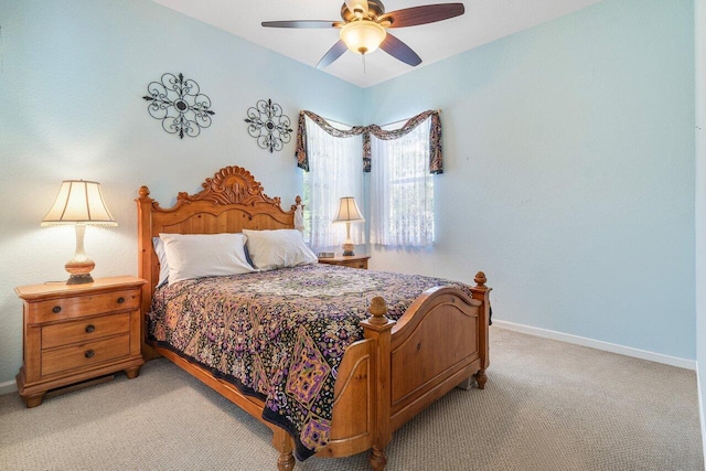 bedroom with a ceiling fan, baseboards, and light carpet