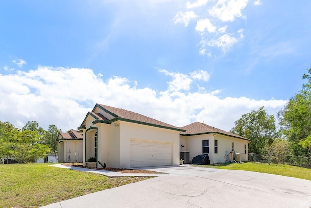 view of front facade featuring central AC unit, concrete driveway, an attached garage, a front yard, and stucco siding