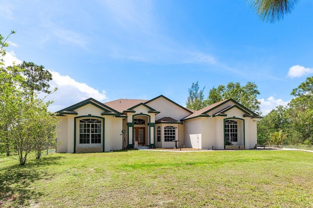 single story home with stucco siding and a front lawn