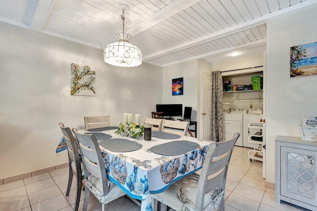 dining room featuring baseboards, an inviting chandelier, washing machine and dryer, light tile patterned flooring, and beamed ceiling