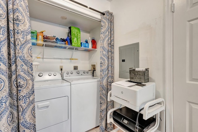 clothes washing area with washer and dryer, laundry area, and electric panel