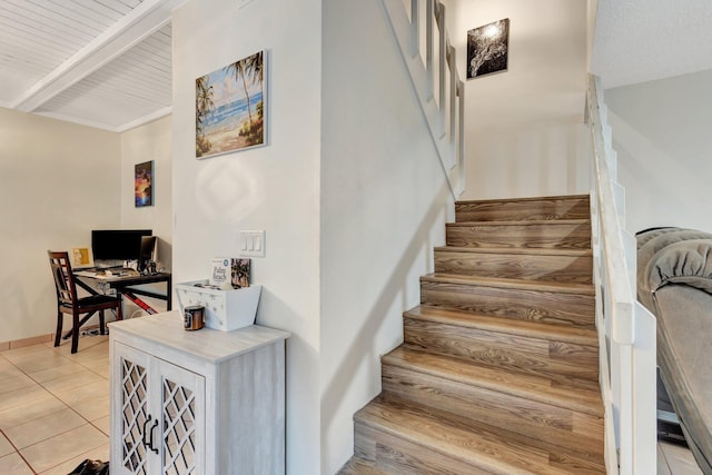 stairs with beam ceiling and tile patterned floors