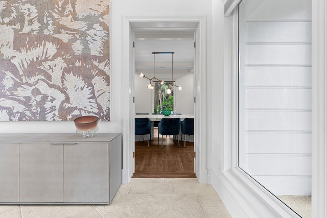 5 Osprey Ct, Ocean Ridge, FL 33435 - corridor featuring tile patterned flooring and a chandelier