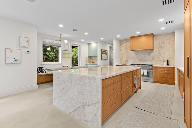 5 Osprey Ct, Ocean Ridge, FL 33435 - kitchen featuring high end stainless steel range, backsplash, a spacious island, light stone counters, and recessed lighting
