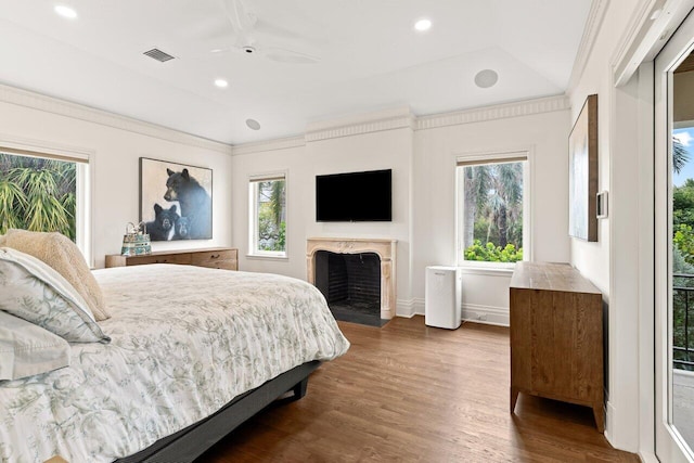 5 Osprey Ct, Ocean Ridge, FL 33435 - bedroom featuring multiple windows, dark wood-style floors, recessed lighting, a fireplace, and ceiling fan