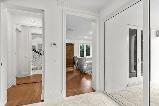 5 Osprey Ct, Ocean Ridge, FL 33435 - hall with ornamental molding, stairs, wood finished floors, and baseboards