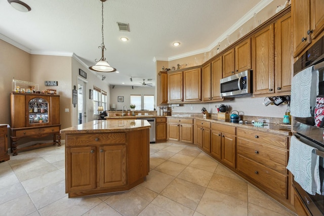 694 Cresta Cir, West Palm Beach, FL 33413 - kitchen with ornamental molding, visible vents, brown cabinets, and appliances with stainless steel finishes