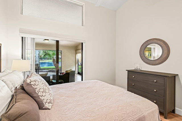 bedroom with access to outside and light wood-type flooring