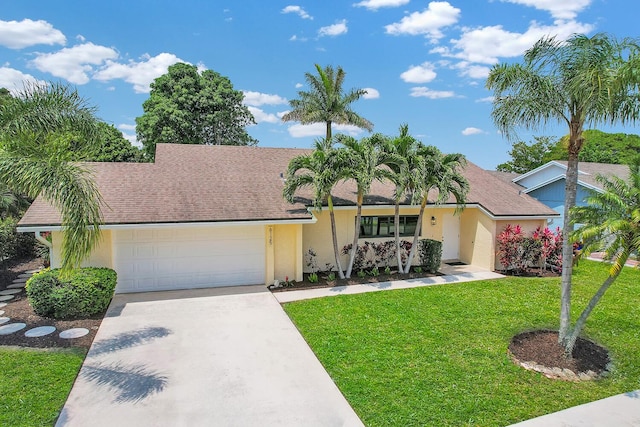 view of front of property with a garage, stucco siding, concrete driveway, and a front lawn