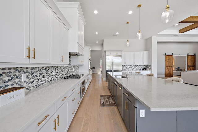 kitchen featuring a sink, white cabinetry, and recessed lighting