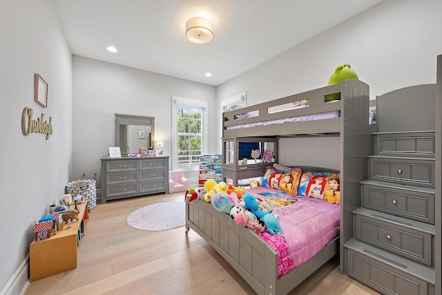 bedroom featuring recessed lighting and wood finished floors