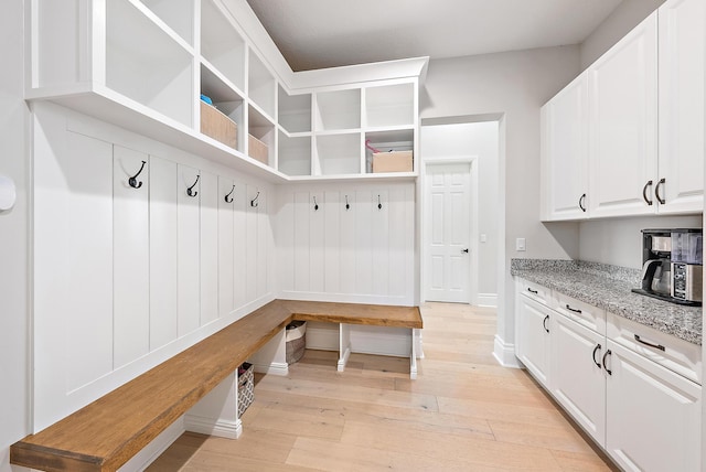 mudroom featuring light wood-style floors and baseboards