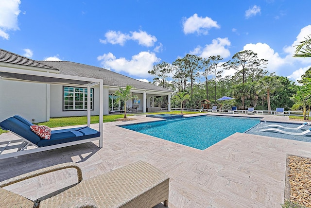 view of pool with a patio area and a pool with connected hot tub