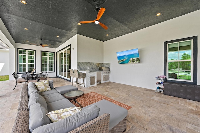 living room with a healthy amount of sunlight, recessed lighting, stone tile floors, and ceiling fan
