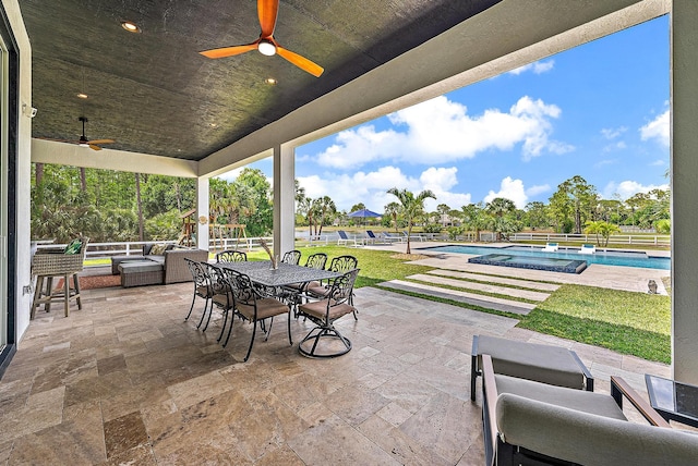 view of patio with an outdoor pool and ceiling fan