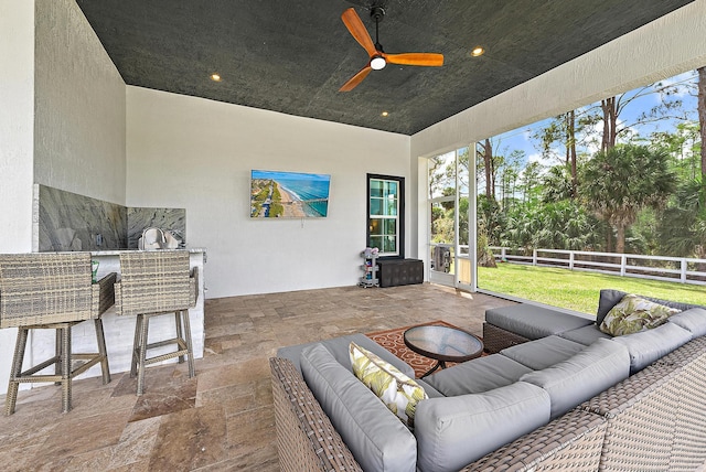 sunroom / solarium featuring outdoor lounge area, a ceiling fan, and outdoor dry bar