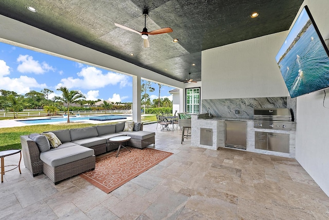view of patio / terrace with exterior kitchen, a fenced in pool, area for grilling, an outdoor hangout area, and fence