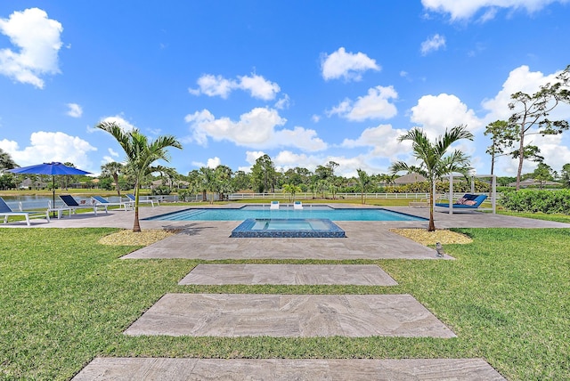 outdoor pool featuring a yard